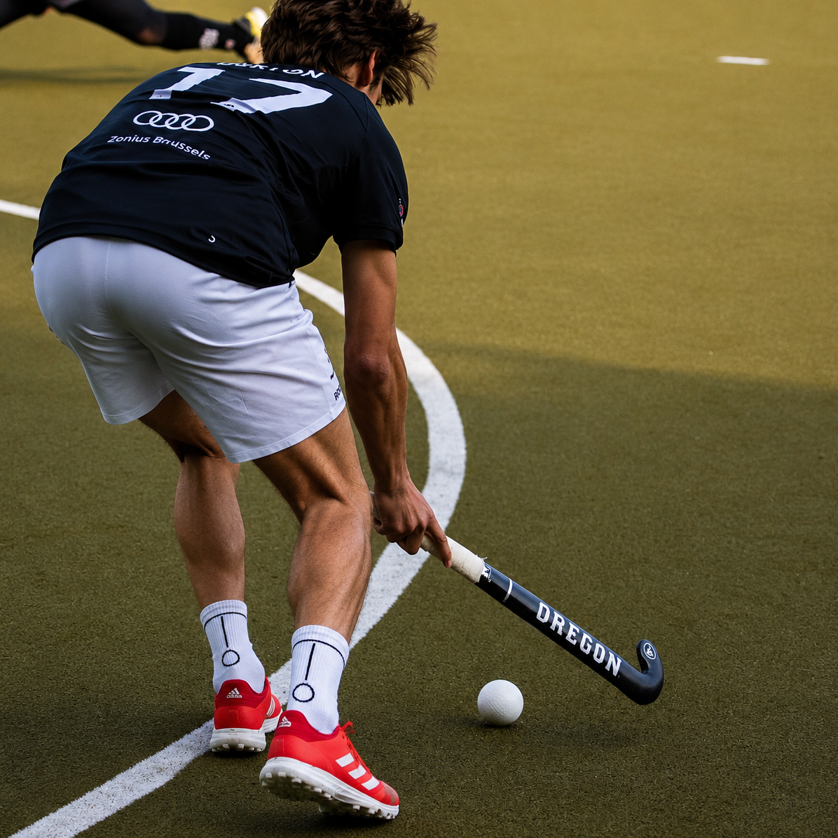 Hockey player practicing on a turf field